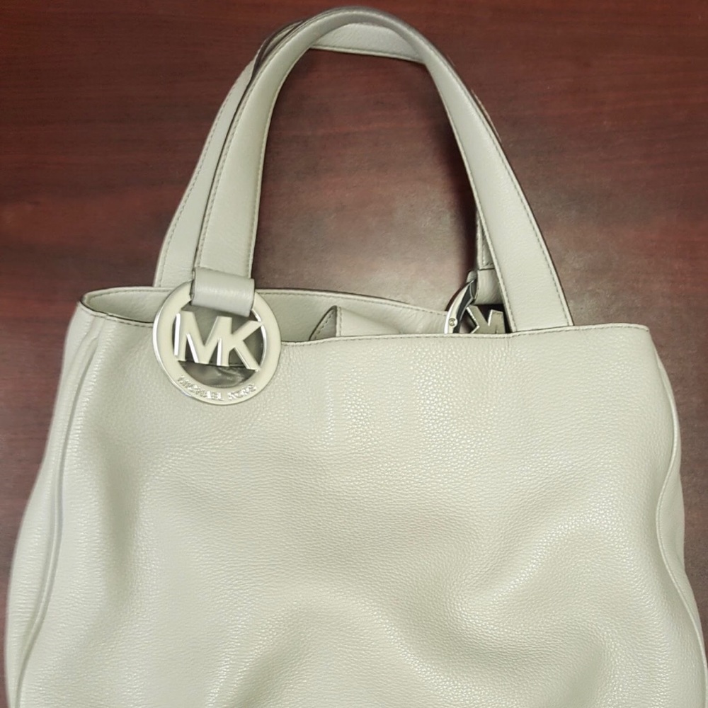 Michael Kors. Neutral in color. Leather purse